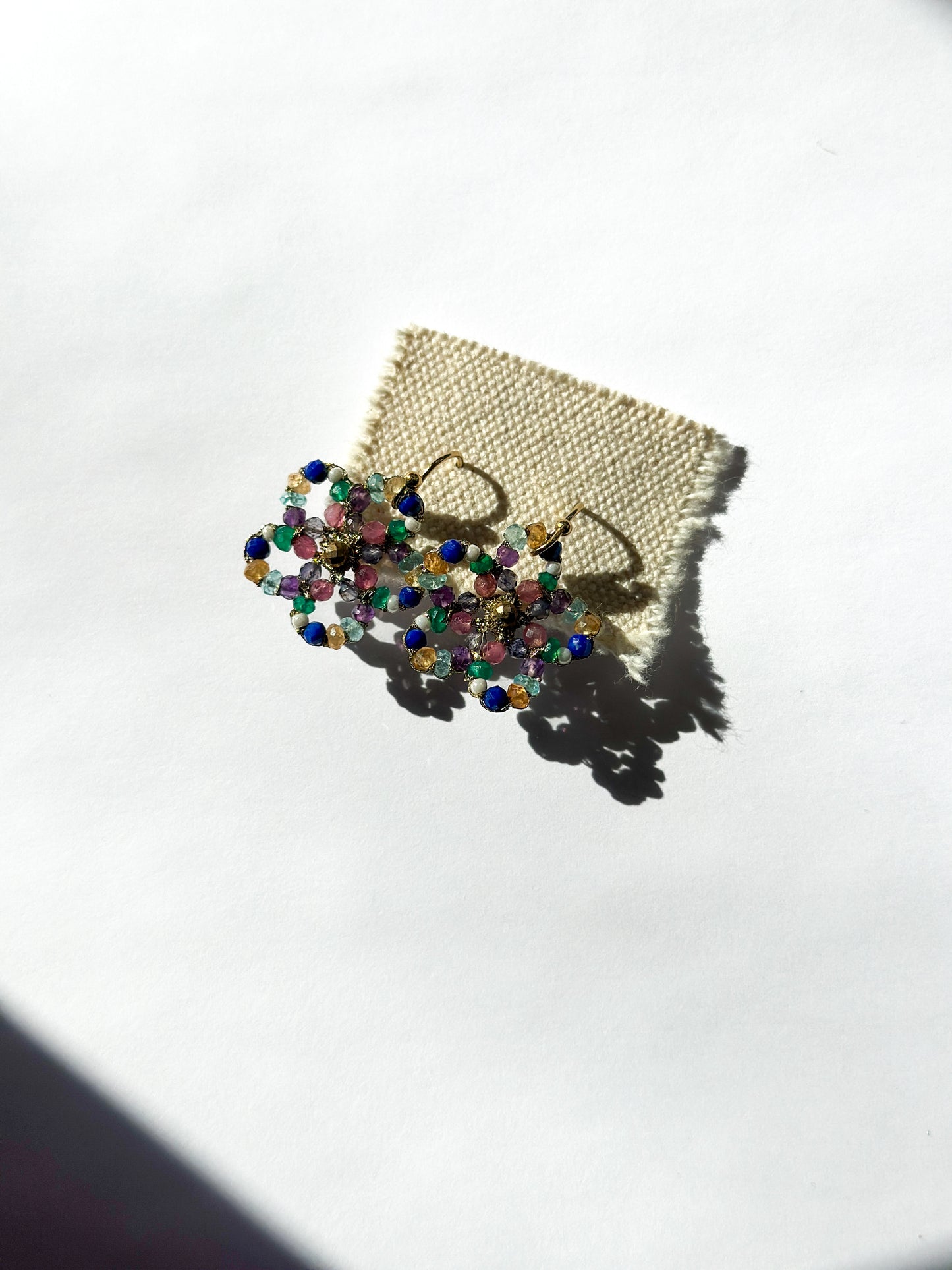 DANIELLE WELMOND | Woven Gold Cord Flower with White Pearl, Chrome, Citrine, Lapis, Apatite, Gold Pyrite and Pink Sapphire Earrings